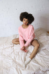 Pink crewneck sweater with a drop shoulder and pink embroidered 'Veins Avec Moi' design on the front.