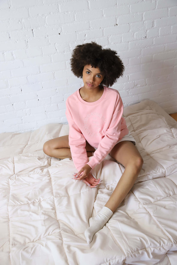 Pink crewneck sweater with a drop shoulder and pink embroidered 'Veins Avec Moi' design on the front.