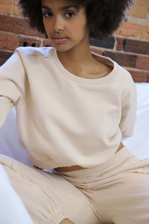 Beige cropped crewneck sweater made from eco-friendly fabrics and designed in Canada.
