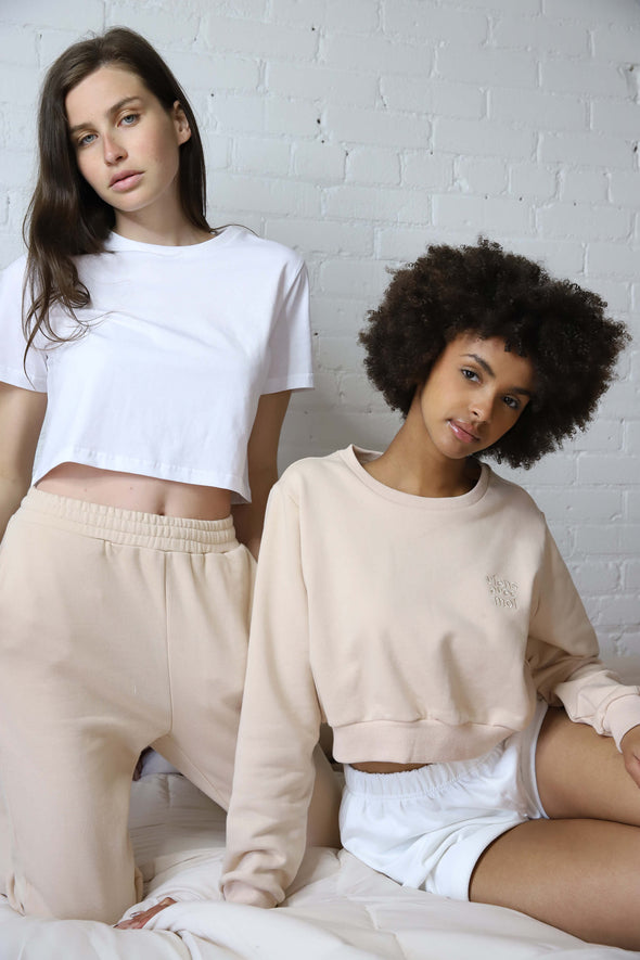 Neutral loungewear sets featuring cropped tees and sweaters and comfortable sweatpants and shorts.