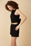 Black shorts with a smocked waist and pockets by Canadian online clothing brand, Viens Avec Moi.