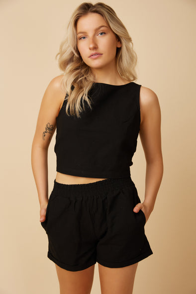 The Date Night Shorts are black linen blend shorts with a smocked waistband and side pockets made by Canadian clothing brand, Viens Avec Moi.