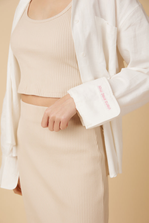 Close up details of the elastic waistband on the oatmeal ribbed knit midi skirt set.
