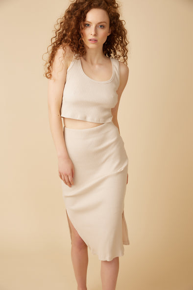 The Feel Good Skirt is an oatmeal coloured ribbed knit bodycon skirt with side slit details.